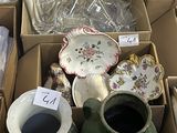 many boxes of different types of pottery on the floor