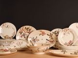 a lot of plates and bowls on the table