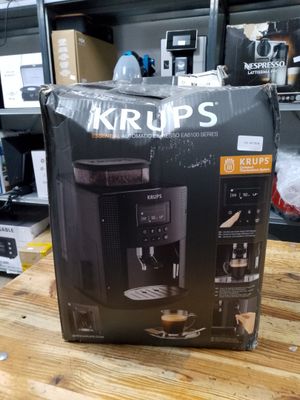 packaging of a coffee machine sitting on top of a wooden table