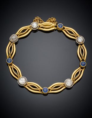 un bracelet en or orné de pierres bleues et blanches