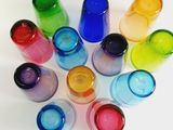 many different colors of water bottles arranged in a circle