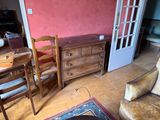 a living room with a couch, chair, table and a dresser