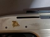 a close up of a gun with a gold design on it