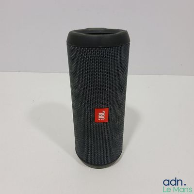a close up of a black speaker on a white surface