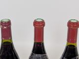 three bottles of wine sitting next to each other on a table