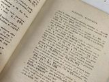 an open book with writing on it on a table