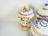 three ceramic containers sitting next to each other on a table