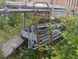 a pile of junk in the yard next to a fence