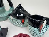 two teapots that are sitting next to each other on a table
