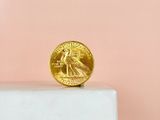 a gold coin sitting on top of a marble block