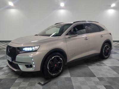 the front of a beige suv parked on a checkered floor