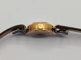 an image of a gold watch with a black leather band