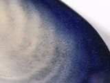 a close up of a blue and white plate on a table