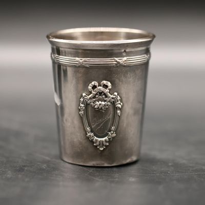 a silver cup that is sitting on a table
