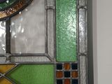 a picture of a stained glass clock hanging on the wall