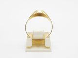 a close up of a gold ring on a white surface