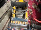 a yellow machine that is sitting on a carpet