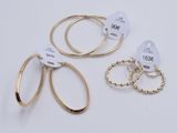 three pairs of gold hoop earrings and a pair of gold hoop earrings