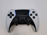 a close up of a video game controller on a white surface