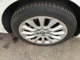 a close up of a tire on a white car