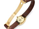 a close up of a watch on a brown leather strap