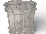 a clear glass container with a lid on a white surface