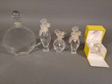 three glass figurines sitting next to a yellow box