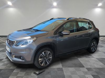 a grey car is parked in a room with a checkered floor