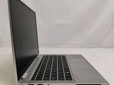 a laptop that is sitting on a white surface
