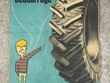 an advertisement for a tractor tire with a boy pointing to it