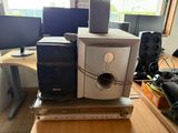 two computer monitors on top of each other on a desk