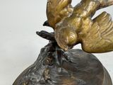 a statue of a bird that is sitting on top of a base