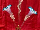 a glass vase with flowers in it on a red background