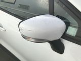 a white car that has a mirror on the side of it