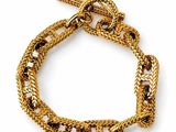 a close up of a gold bracelet on a white background