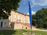 a large blue flag in front of a building