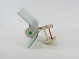 a small white object with a red wire attached to it