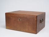 an old wooden box sitting on top of a white surface