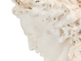 sculpture of a woman ' s head with curly hair on a white background
