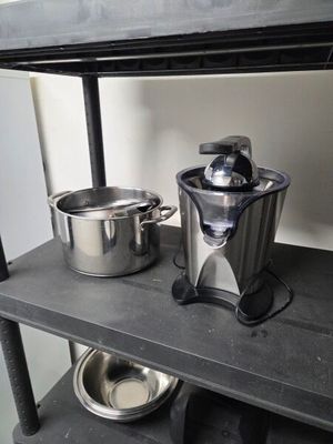 two pots and a blender on a shelf in a kitchen