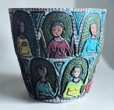 a pot with a picture of people on it