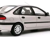 a silver car that is parked on a white surface