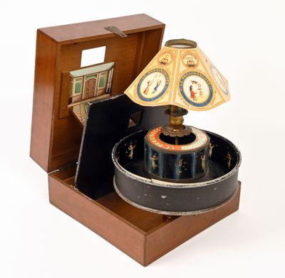 a small wooden box with a lamp inside of it