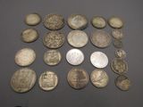 some old coins are arranged on a table with a black background
