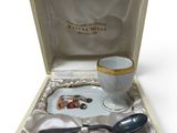 a small cup and spoon in a box on a table
