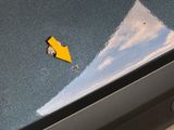 a yellow arrow stuck in the side of a blue car