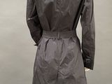 an image of a mannequin dressed in a black trench coat