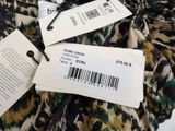 two tags on a dress hang from a hanger on a hanger