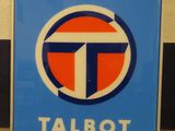 a sign that says talbot on it in front of a wall