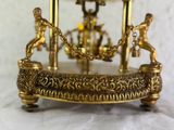 a gold clock that is sitting on a table